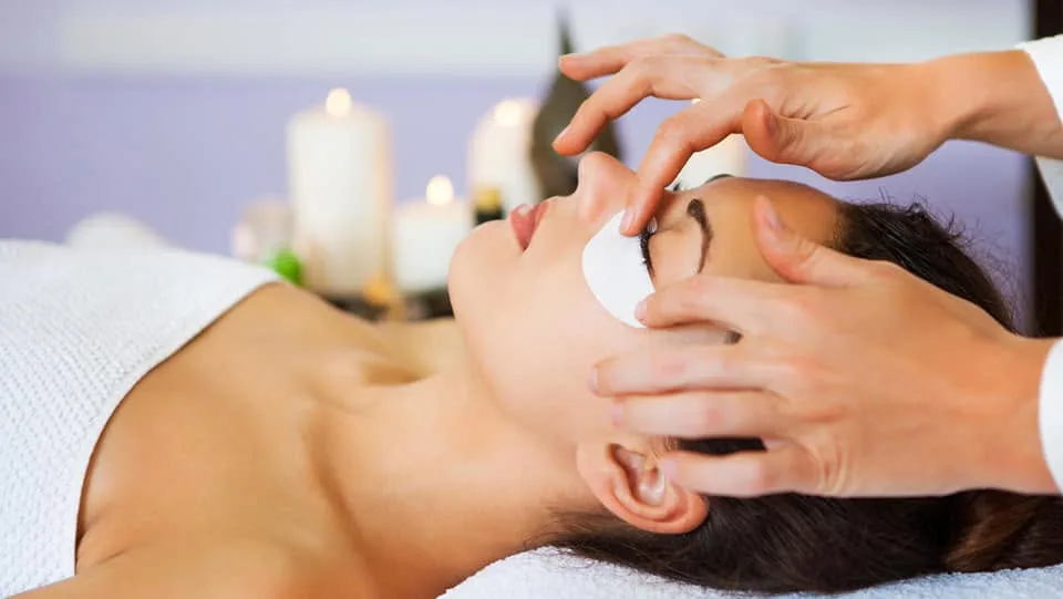 A beauty treatment in a warm, candlelit room — attentive, personal, and calm; the feel of every appointment at Bewaxxxed